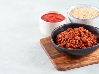 Vegan tomato bolognese ragu with soya protein granules in bowl