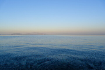Aegean Sea surface and horizon in morning dawn. In Güzelçamlı, Kuşadası, Aydın, Turkey