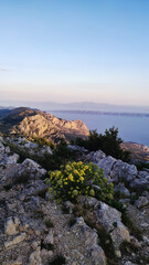 Scenic view of rocky mountains and coastal landscape during sunset