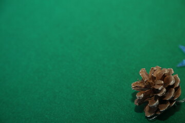 Season's greetings scene.Share your warm wishes with this image idea.view of magnificent giftbox with ribbon, sparkling ornaments, frosty fir, ball, cone on green backdrop, ready for personalized ad