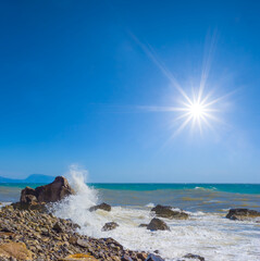 stony stormy sea coast at the summer sunny day
