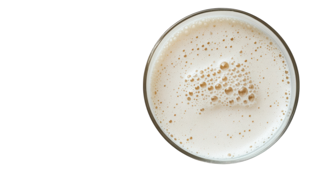 A Refreshing Glass of Milk with Bubbles on a White Surface - Perfect for Food and Beverage Themes in Advertising or Editorial Use.