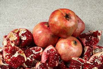 Ripe pomegranates, peeled and whole, the concept of benefits and vitamins in fruit.