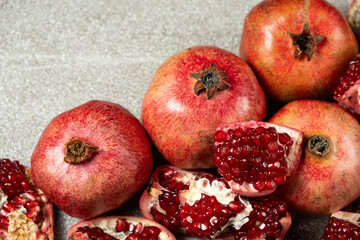 Ripe pomegranates, peeled and whole, the concept of benefits and vitamins in fruit.