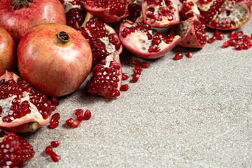 Ripe pomegranates, peeled and whole, place for text