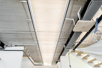 renovation and construction of houses and apartments. an unfinished house. The ceiling is without interior decoration. Grey concrete ceiling with steel beams. the construction of an apartment.