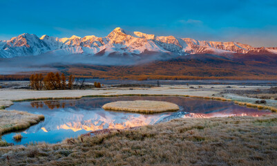 Beautiful Altai mountains in autumn framed by and reflections on a tranquil lake, showcasing serene...
