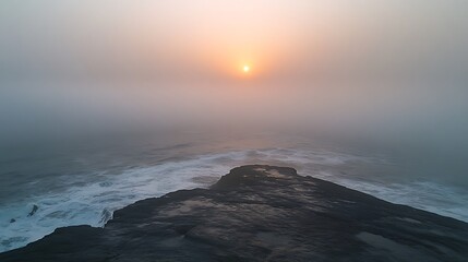 Obraz premium Misty Sunset Over Coastal Rocks: An Atmospheric Seascape. AI Generated