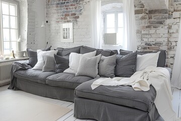 Obraz premium Modern white living room featuring a stylish dark grey sofa for contemporary elegance