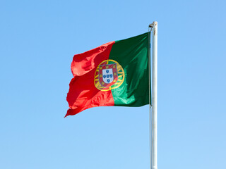 Portuguese flag on a pole, blue sky