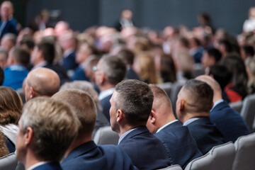Professional audience attending a business seminar, demonstrating corporate networking and collaboration.