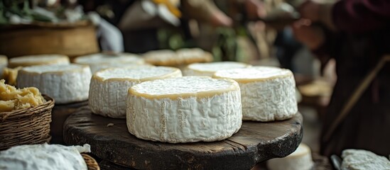 Handcrafted goat cheese displayed at a vibrant medieval festival with natural rustic decorations and traditional craftsmanship atmosphere