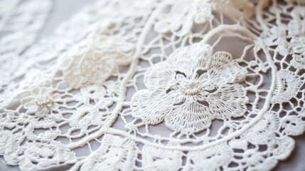 Obraz premium Ornate vintage lace fabric with intricate floral patterns showcasing craftsmanship and timeless elegance for textile and design projects.