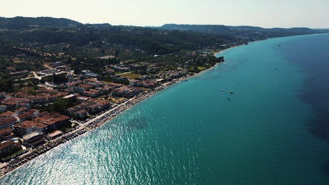 Drone footage panorama of Pefkochori beautiful tourist city by the sea on Kassandra peninsula, Halkidiki, Greece