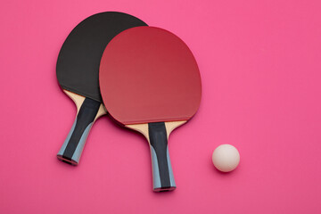 Professional Table Tennis Paddles and Ball on Vibrant Pink Background | Modern Sports Equipment