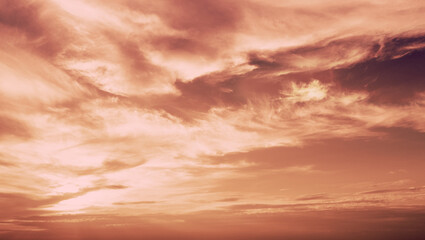 Fototapeta premium Cloudy sky at sunset in Mocha mousse trendy color. Sky texture. Abstract nature background