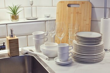 Clean washed dishes near the kitchen sink. 