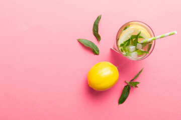 Caipirinha, Mojito cocktail, vodka or soda drink with lime, mint and straw on table background. Refreshing beverage with mint and lime in glass top view flat lay