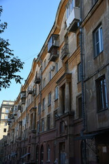 Architecture of old Soviet Union houses in Stalin's Empire style. Exterior of the facade of a vintage residential building in Russia