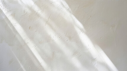 Obraz premium Texture of a wall illuminated by sunlight, creating soft shadows in a serene space