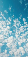 Obraz premium Vast expanse of blue sky dotted with fluffy white cumulus clouds, environment,picture