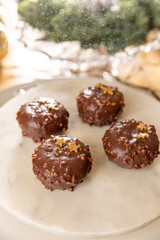 Four chocolate cakes covered with nuts