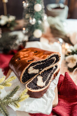 Poppy seed roll on the festive table, Scandinavian style, Scandinavian Christmas, candles, Christmas tree