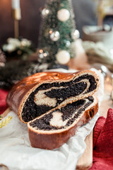 Poppy seed roll on the festive table, Scandinavian style, Scandinavian Christmas, candles, Christmas tree