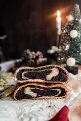 Poppy seed roll on the festive table, Scandinavian style, Scandinavian Christmas, candles, Christmas tree