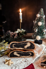 Poppy seed roll on the festive table, Scandinavian style, Scandinavian Christmas, candles, Christmas tree