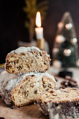 Christmas stollen decorated with a cinnamon stick on a festive table, Scandinavian style, Scandinavian Christmas, stollen with powdered sugar, raisins, candied fruits