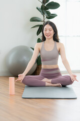 Asian young women doing yoga exercises during their holiday at home