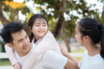 Obraz premium Happy Family Enjoying Outdoor Wellness Activities Together in a Park Setting
