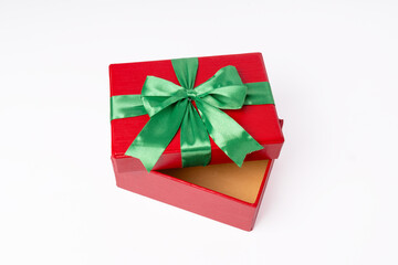 A red box with a green bow on top of it. The box is open and the bow is visible