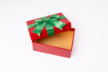 A red box with a green bow on top of it. The box is open and the bow is visible