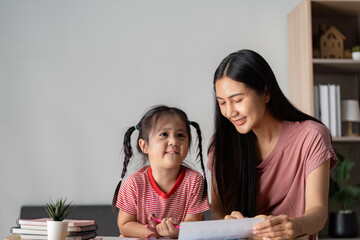 Happy Parent and Child Engaged in Learning Activities at Home with Books and Smiles