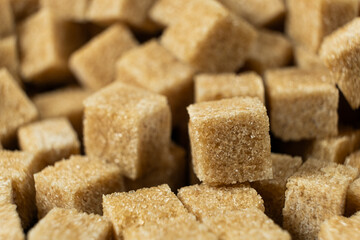 Macro cubes of brown cane unrefined demerara sugar.