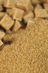Brown cane unrefined demerara sugar in the form of crystals and cubes