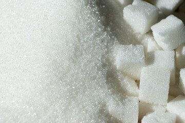 White refined beet sugar in the form of crystals and cubes.