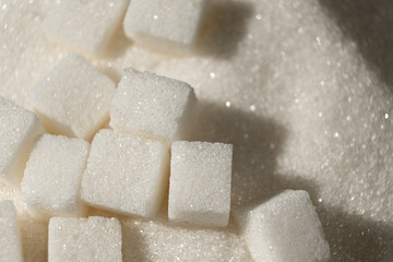 White refined beet sugar in the form of crystals and cubes.