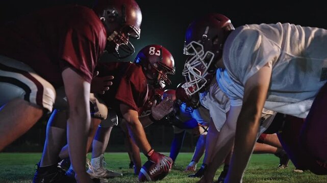 American Football Championship Start Teams Ready: Professional Players, Aggressive Face-off, Start Pushing, Tackling. Competition Full of Brutal Energy, Skill. Cinematic Slow Motion. Dramatic Sport