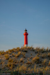 red lighthouse on the coast