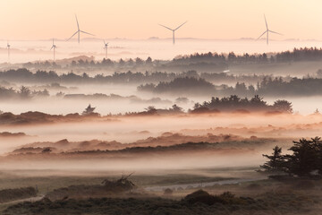 Beautiful sunrise at Lighthouse of Rubjerg Knude. Denmark north coast with wonderfully illuminated fog.
