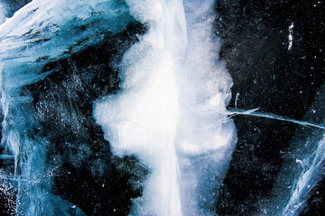 Deep blue ice texture, lake water frozen in winter, icy wallpaper, white snow © dramapalma