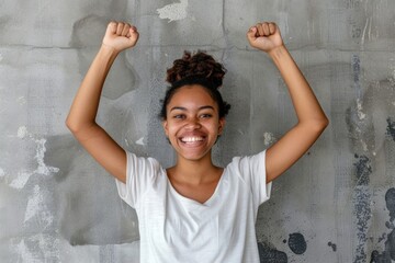 Young writer wins competition  exudes joy against grey backdrop.