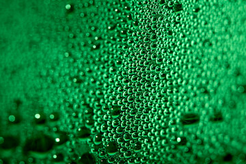 Close Up of Condensation Floating Liquid Water Bubbles and Drips on Glass from Rain