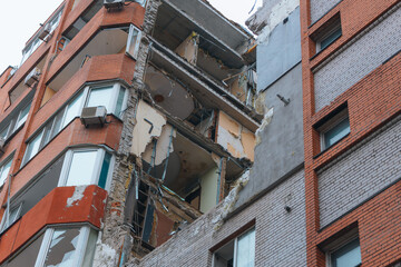 Fototapeta premium Russian missile hits residential building in Dnipro, Ukraine. Aftermath of enemy attack on city. Destroyed residential multi-story building. Close-up. War. Aftermath of explosion.