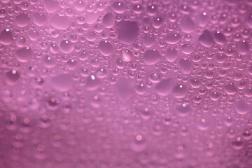 Close Up of Condensation Floating Liquid Water Bubbles and Drips on Glass from Rain