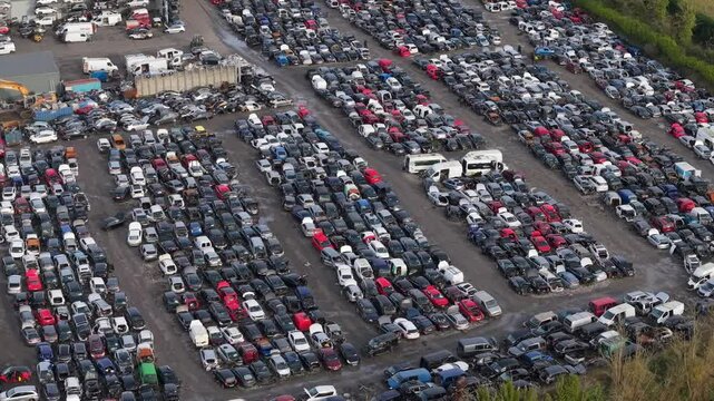 Car scrap yard in Kildare, Ireland, with rows of vehicles under cloudy skies