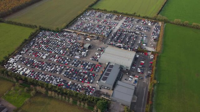 Car scrap yard aerial view in County Kildare, Ireland, surrounded by fields